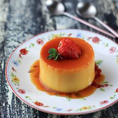 Homemade Dessert Caramel Pudding with Strawberry Topping. Copy Space for Text