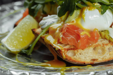 Eggs Benedict with avocado toast. Delicious and healthy breakfast. Healthy food concept