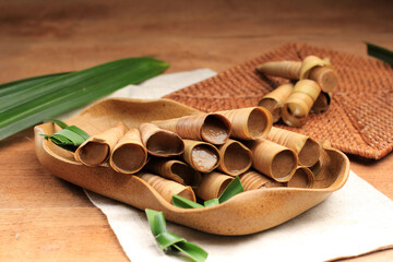 Fototapeta na wymiar Clorot is Javanese Traditional Food, Made from Rice and Brown Sugar Wrapped with Coconut Leaves