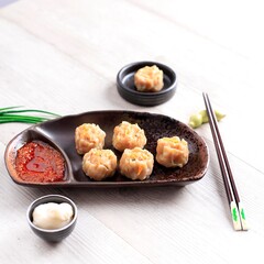 Dimsum is a Chinese Traditional Food, One of Varian Dimsum is Shicken Shiu May, serve with Chili Oil and Mayonaise