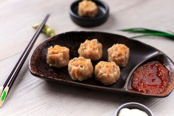 Dimsum is a Chinese Traditional Food, One of Varian Dimsum is Shicken Shiu May, serve with Chili Oil and Mayonaise