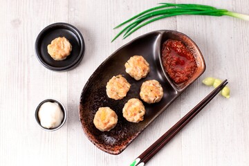 Dimsum is a Chinese Traditional Food, One of Varian Dimsum is Shicken Shiu May, serve with Chili Oil and Mayonaise