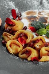 Pancakes with cheese in orange sauce served with caramelized nuts and almonds. Appetizing dish. Culinary photography, a proposal to serve a meal