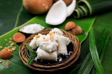Kue Putu, Indonesian Traditional Cake Made from RIce Flour, Palm SUgar, Pandan Leaf, and Shredded Coconut. Come with Cylinder Shape with Bamboo Pipe