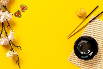 Chinese New Year tabble setting with fortune cookies and golden chopsticks