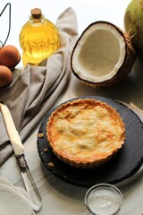 Coconut Pie, SLiced in Triangle. Made from Butter and Flour, and Stuffed with Young Coconut Flesh in the Center. Serve on Round Stone Plate
