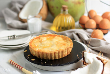 Homemade Round Coconut Pie. Made from Butter and Flour, and Stuffed with Young Coconut Flesh in the Center. Serve on Round Stone Plate
