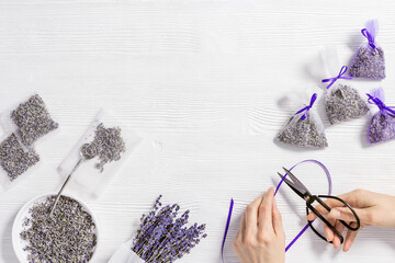 Woman hands hold scissor, make DIY lavender sachets for home,  natural scented bags from organza...