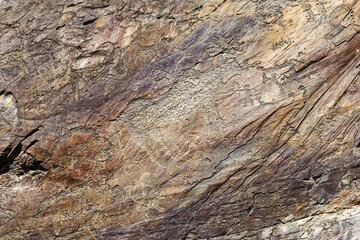 Drawn figure animals and hunter on the stone wall. Rock painting in Karakol Ethno-natural Park Uch Enmek, Altai Republic, Russia. Historical heritage in Karakolskaya valley.