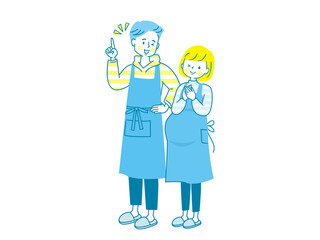 妊娠中の笑顔の女性とエプロン姿の夫