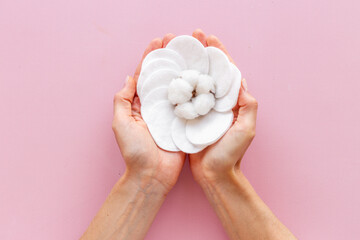 Female hands holding cotton pads for cleansing skin and care