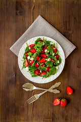 Vegetarian diet - green spinach salad with strawberry and goat cheese