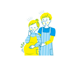 妊娠中の笑顔の女性とエプロン姿の夫