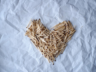 heart made of matches on a white background