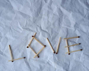 word love from matches on a white background