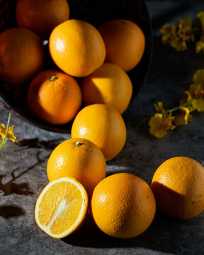 Hard light photo of an abundance of oranges.