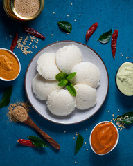 Flatlay of South Indian idlies surrounded by spices. 