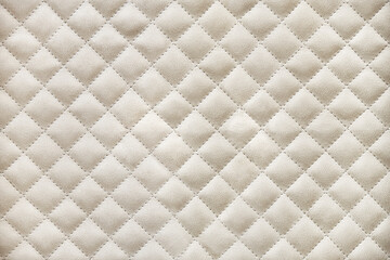 Elegant wardrobe facades covered with light beige alcantara quilted by rhomb pattern close view - obrazy, fototapety, plakaty