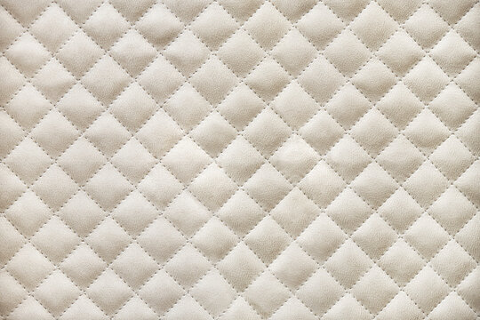 Elegant wardrobe facades covered with light beige alcantara quilted by rhomb pattern close view