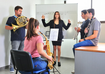 Music conservatory teacher, corrects the lesson in the classroom.