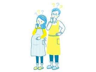 疑問を持つ若い妊婦さんとエプロン姿の夫