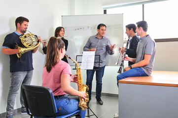 Music conservatory teacher, corrects the lesson in the classroom.