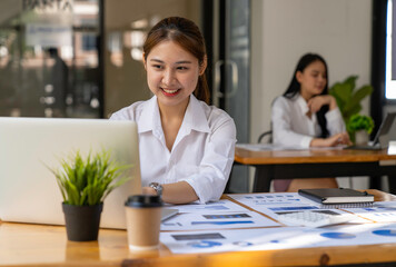 Businesswoman accountant working audit and calculating expense financial annual financial report balance sheet statement, doing finance making notes on paper checking document.