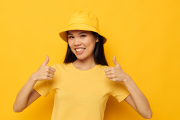 Charming young Asian woman wearing a yellow hat posing emotions Monochrome shot