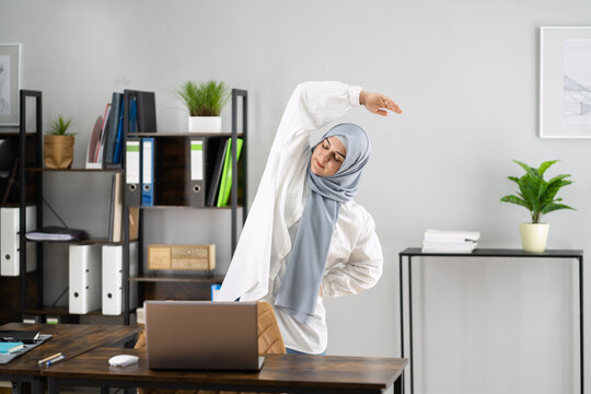 Woman In Hijab Standing And Stretching In Front