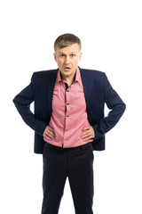 business man in a suit. the young man put his hands on his hips and brazenly looks at the camera at us. isolated