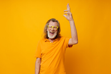 Senior grey-haired man hand gestures emotions yellow glasses monochrome shot