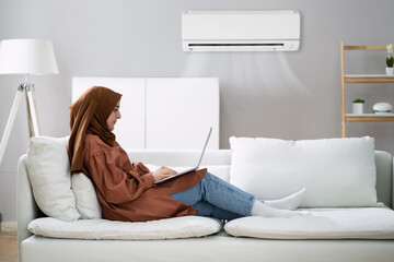 Woman Enjoying The Cooling Of Air Conditioner