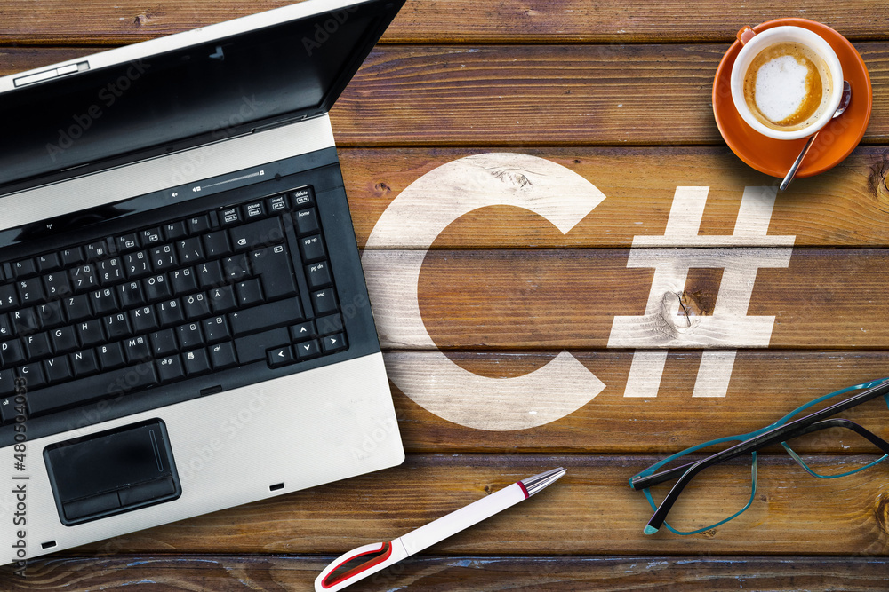 Poster c sharp programming language. c# and laptop, glasses and coffee on wooden table