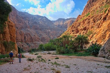 Senior couple hiking along Wadi Shab in Oman