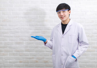 Portrait studio shot Asian professional male scientist in white lab coat rubber gloves standing...