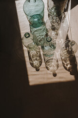Old vintage translucent bottles with sunlight shadows. Antique home interior decoration