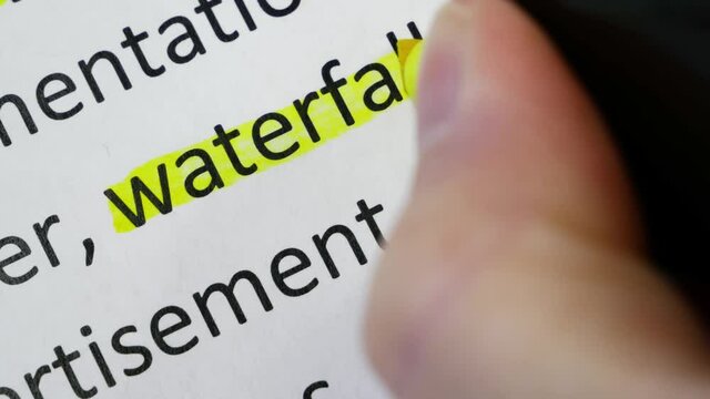 Word waterfall undelnines among other words printed on white paper. Waterfall development concept. Water fall SDLC system development life cycle methodology software