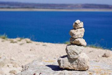 Fototapeta na wymiar stack of zen stones tower on the beach