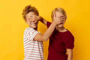 Obraz premium two joyful children cuddling fashion childhood entertainment yellow background