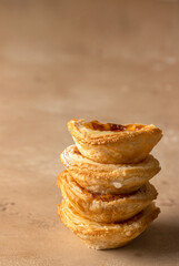 Close up of Pasteis de Belem stack. Typical Portuguese egg custard tart dusted with cinnamon.