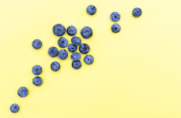 Trendy seamless pattern of blueberries. Blueberry pattern isolated on yellow background