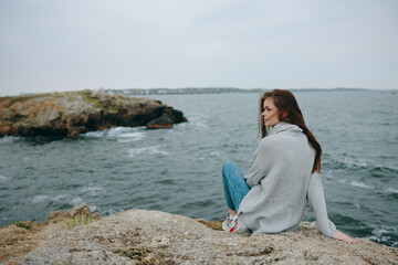 portrait of a woman long hair nature rocks coast landscape female relaxing