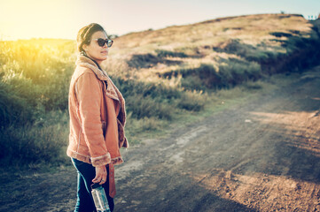 Naklejka premium Close up of a young woman on the road, latin woman on a highway road, portrait of a woman on a road, woman on a road