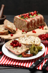 Traditional French terrine covered with bacon on dark wooden background