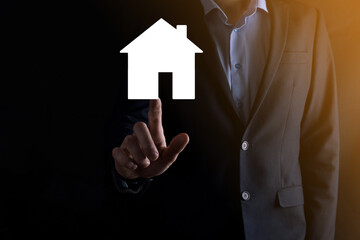 Fototapeta na wymiar Businessman male hand holding house icon on blue background. Property insurance and security concept.Real estate concept.Banner with copy space.