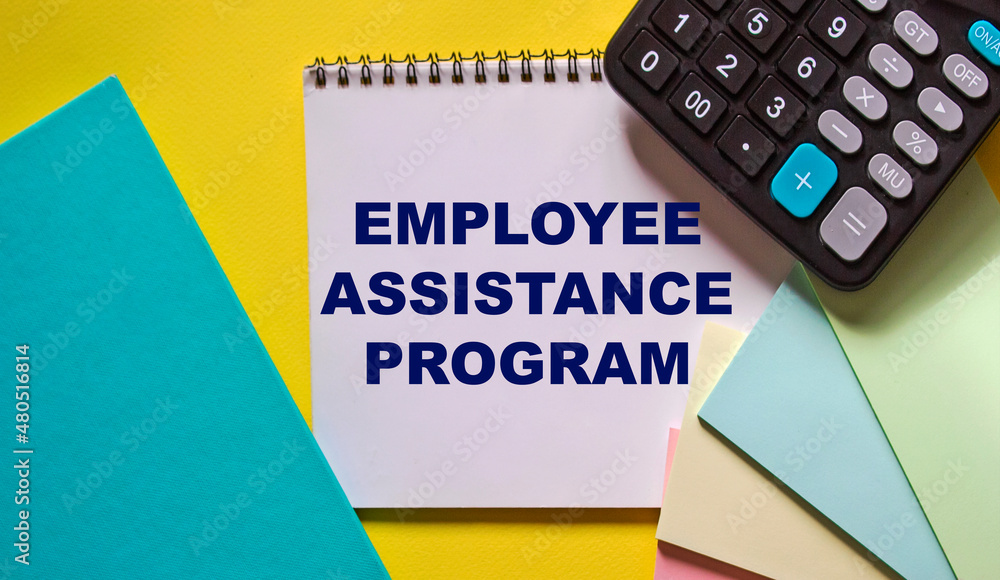 Wall mural employee assistance program business text concept written on notepad and yellow background with calc
