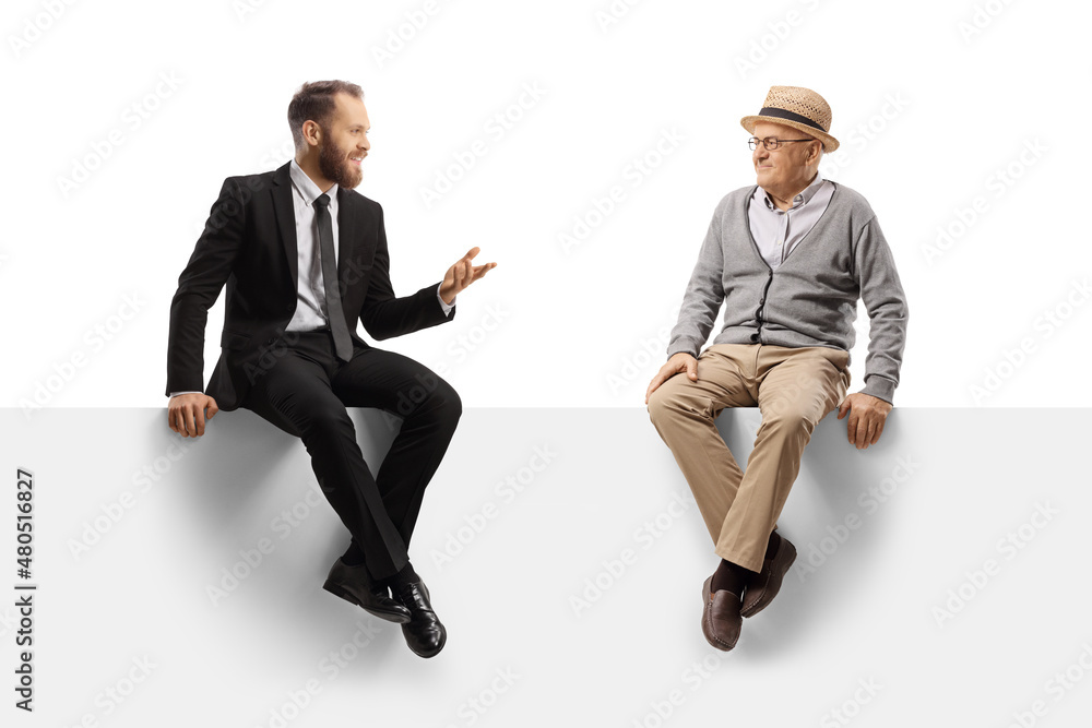 Sticker Professional young man sitting on a panel and having a conversation with an elderly man