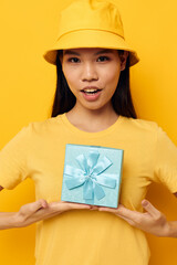 Charming young Asian woman with a gift box in his hands surprise emotions isolated background unaltered