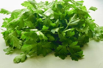 Green juicy parsley on a white background. fresh seasoning