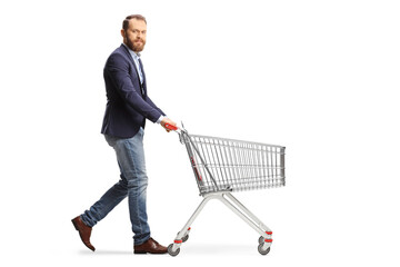 Bearded guy walking and pushing and empty shopping cart